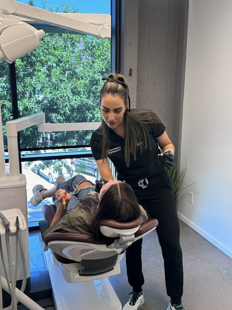 Daniela MIllyard performing an aesthetics service on a client.